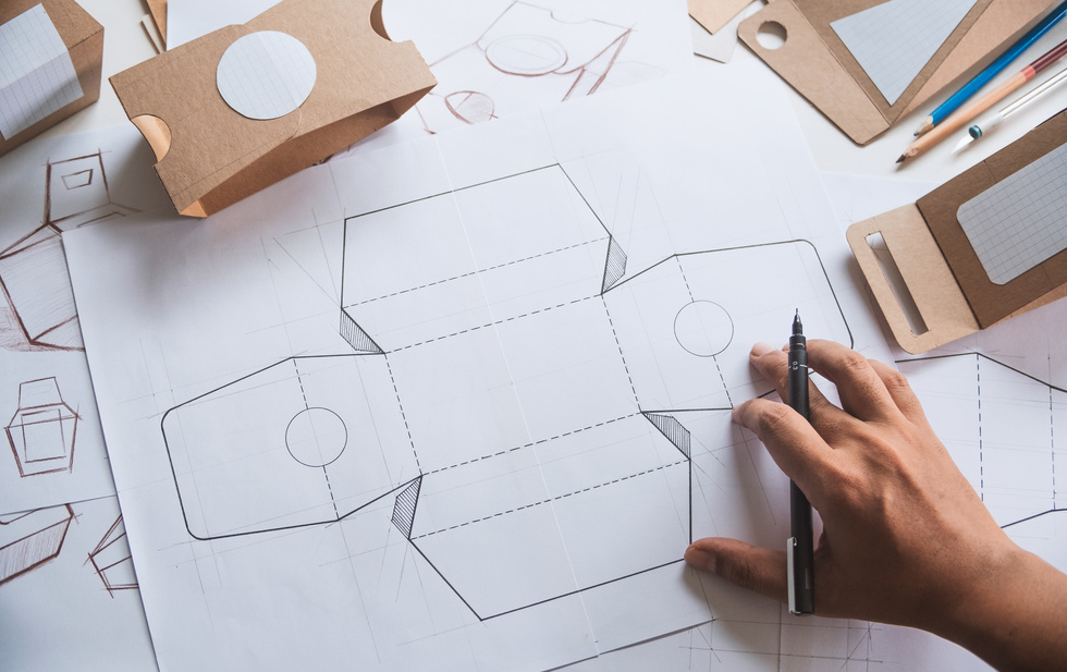 Designer sketching drawing design Brown craft cardboard paper product eco packaging mockup box development template package branding Label . designer studio concept .